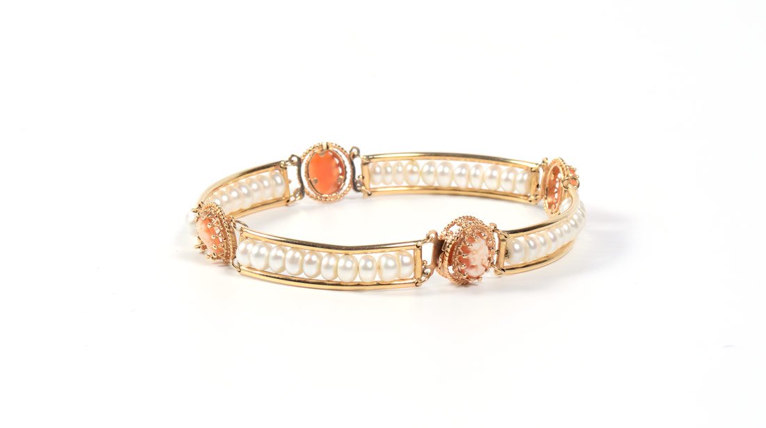 14K GOLD PEARL & CAMEO BRACELET: 14K PEARL AND CAMEO BRACELET: 14K yellow gold bracelet with bands of freshwater pearls and 4 carved shell portrait cameos. Pearls measure approx. 5.5 mm. Locking closure. Length 7.5". Gold Weight appr