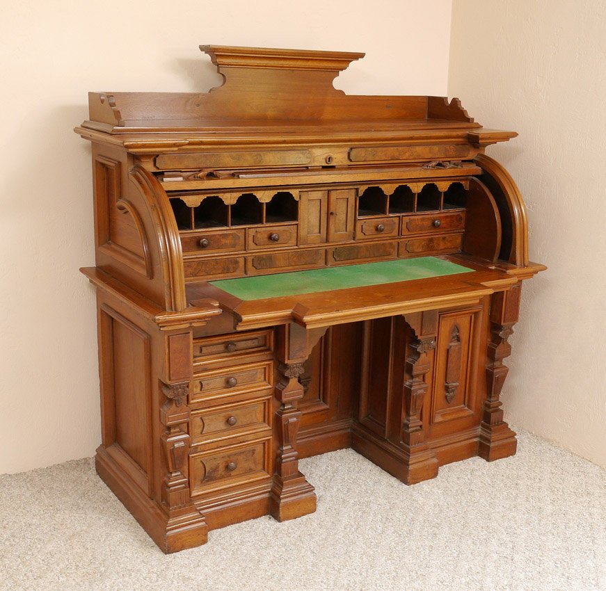 VICTORIAN RENAISSANCE CYLINDER DESK: VICTORIAN ERA RENAISSANCE REVIVAL CYLINDER ROLL TOP DESK: Top with architectural gallery and candle stands, cylinder roll front with burl accents. Interior with 2 doors, 4 drawers, pigeon holes with c