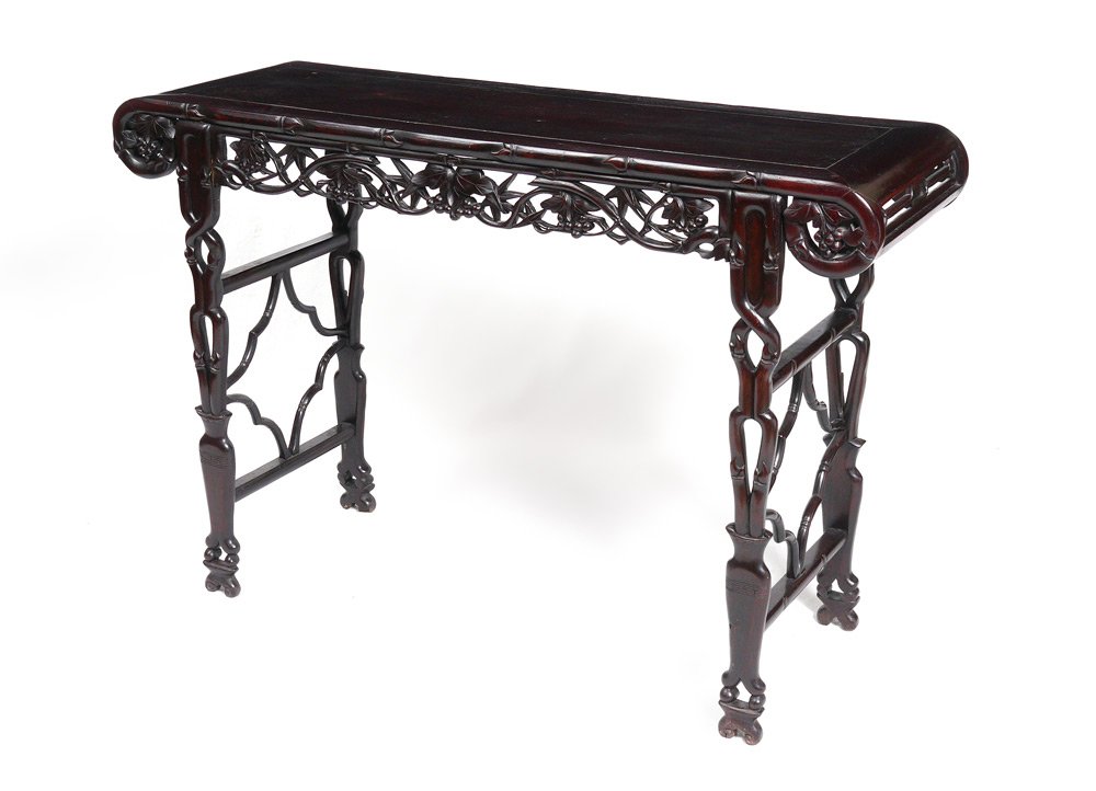 CHINESE CARVED ALTAR TABLE: CHINESE CARVED ALTAR TABLE: Top with carved scroll ends, pierced carved skirt and legs with foliate motifs. Measures 33 1/2" h. x 49 1/2" x 16 1/2".