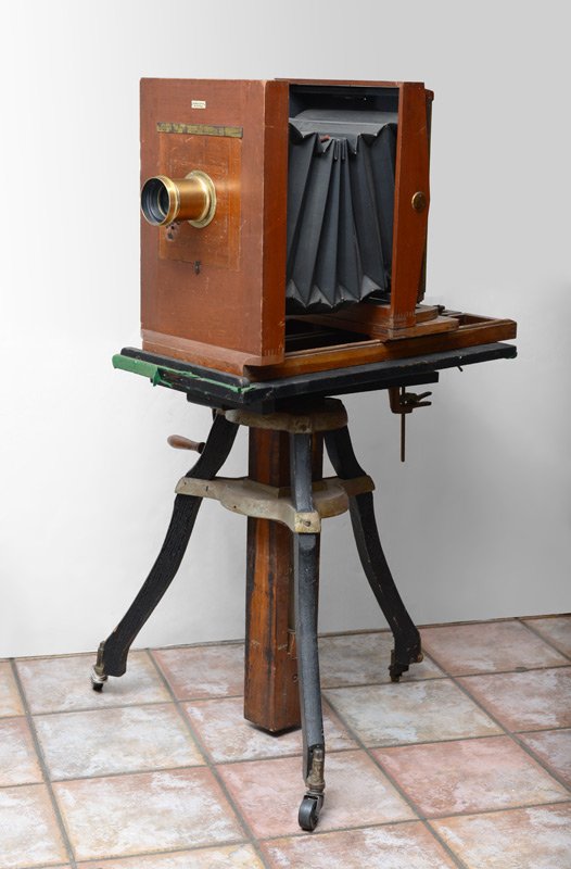 ANTHONY SCOVILL 8 X 10 STUDIO CAMERA ON TRIPOD: ANTHONY SCOVILL 8 X 10 STUDIO CAMERA ON TRIPOD: Circa early 20th century, originally a 8'' x 10'', now holds s 5'' x 7'' plate. Mahogany wood case, black fabric bellows. Ivorine plaque on front reads