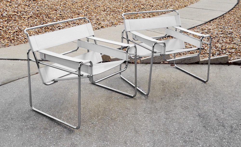 PAIR WASSILY LEATHER & STEEL ARM CHAIRS: PAIR OF WASSILY CHAIRS: Bent chromed steel and white leather modernist style arm chairs designed by Marcel Breuer. Measures approx. 29"h. x 31" x 26".