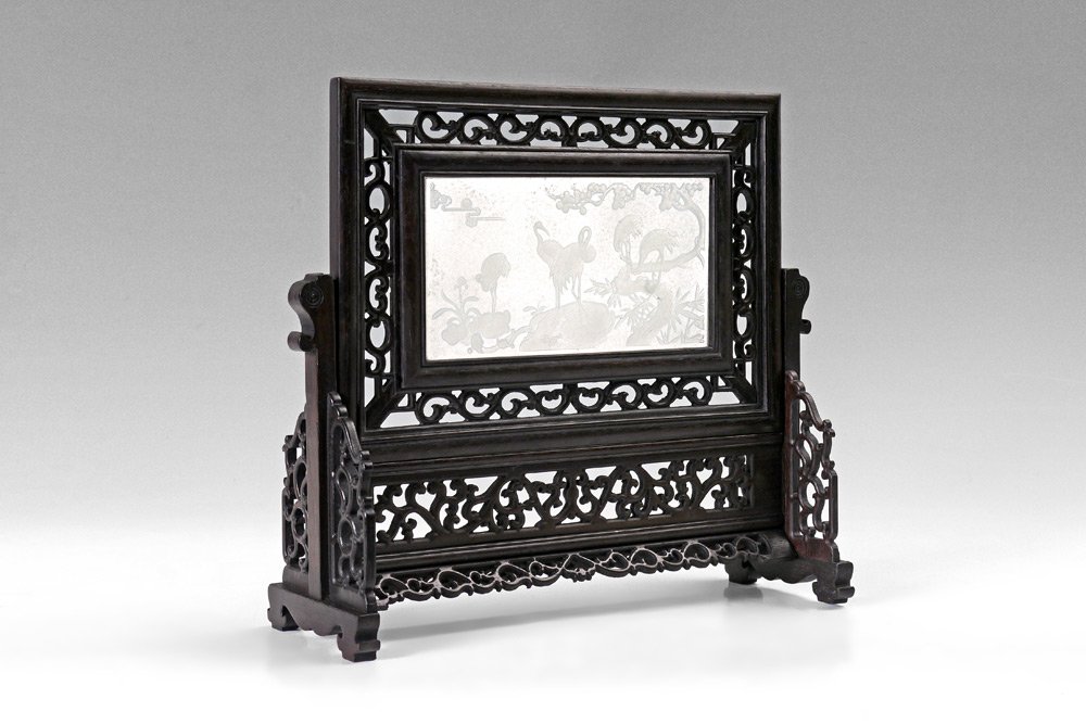 CARVED STONE ORIENTAL TABLE SCREEN: CARVED STONE ORIENTAL TABLE SCREEN: Pierced carved stand and frame, translucent carved white stone (jade?) panel featuring cranes in trees. Overall measures 12 1/2'' h. x 13 1/2'' x 4 1/2''. Actual ag