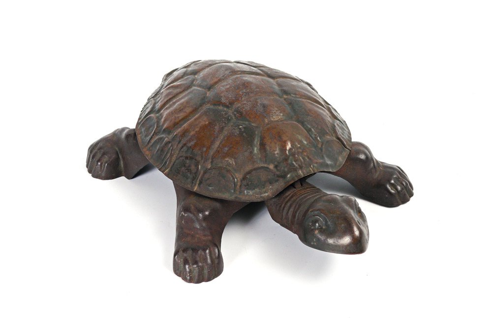 FLIP TOP MECHANICAL TURTLE SPITTOON: FLIP TOP MECHANICAL TURTLE SPITTOON: Patinated metal floor spittoon in the form of a turtle or tortoise. Press on head and shell opens to reveal spittoon. Overall measures 4" h. x 14 1/4" x 10 1/2".