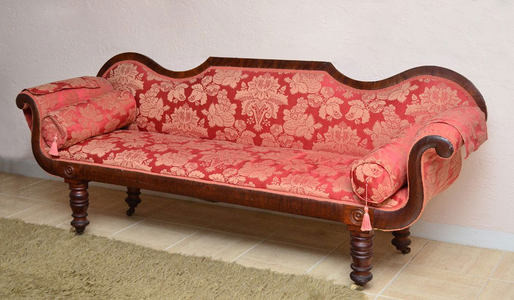 19TH CENTURY SCROLL ARM SOFA: 19TH CENTURY SCROLL ARM SOFA: Shaped back rail, scroll arms, turned legs on castors. Salmon upholstery with floral pattern. Overall 30 1/4" h. x 80" x 22".