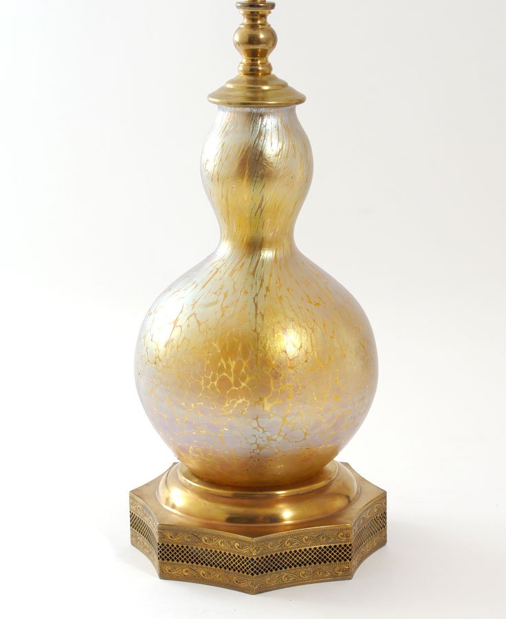 SIGNED LOETZ PAPILLON ART GLASS VASE / LAMP: SIGNED LOETZ PAPILLON ART GLASS VASE / LAMP: Mottled iridescent glass, gourd shaped. Brass reticulated base. Glass measures 9'', lamp is 25'' tall overall. Glass is signed Loetz Austria. Sold with clo