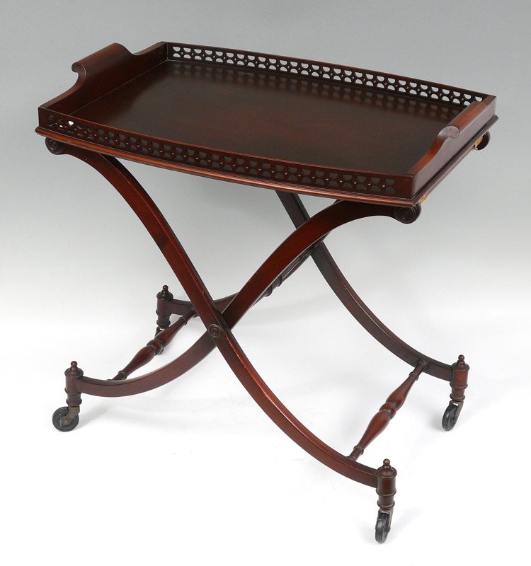 MAHOGANY TEA TRAY TABLE: MAHOGANY TEA TRAY TABLE: Lift off tray, folding base on castors. Overall 27 1/2" h. x 27 1/4" x 18".
