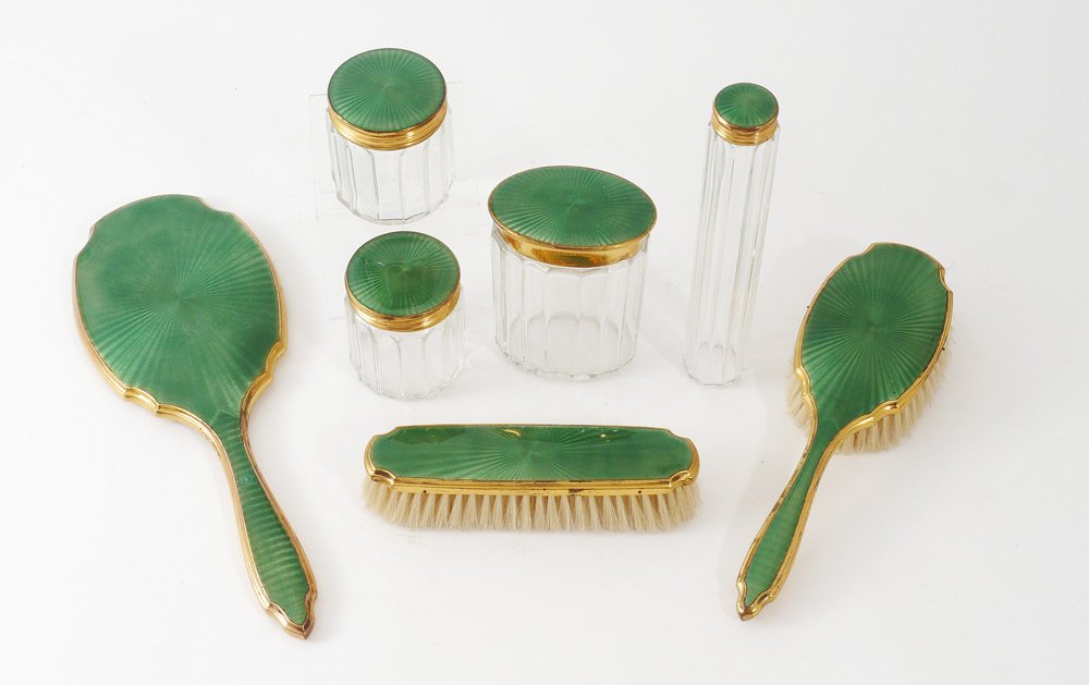 7 PIECE GERMAN GUILLOCHE ENAMEL DRESSER SET: 7 PIECE GERMAN GUILLOCHE ENAMEL DRESSER SET: Guilloche and gilt metal mounted to include hand mirror, hand brush, bar brush, 4 jars of assorted sizes. Marked Made in Germany, mirror measures 11" long.