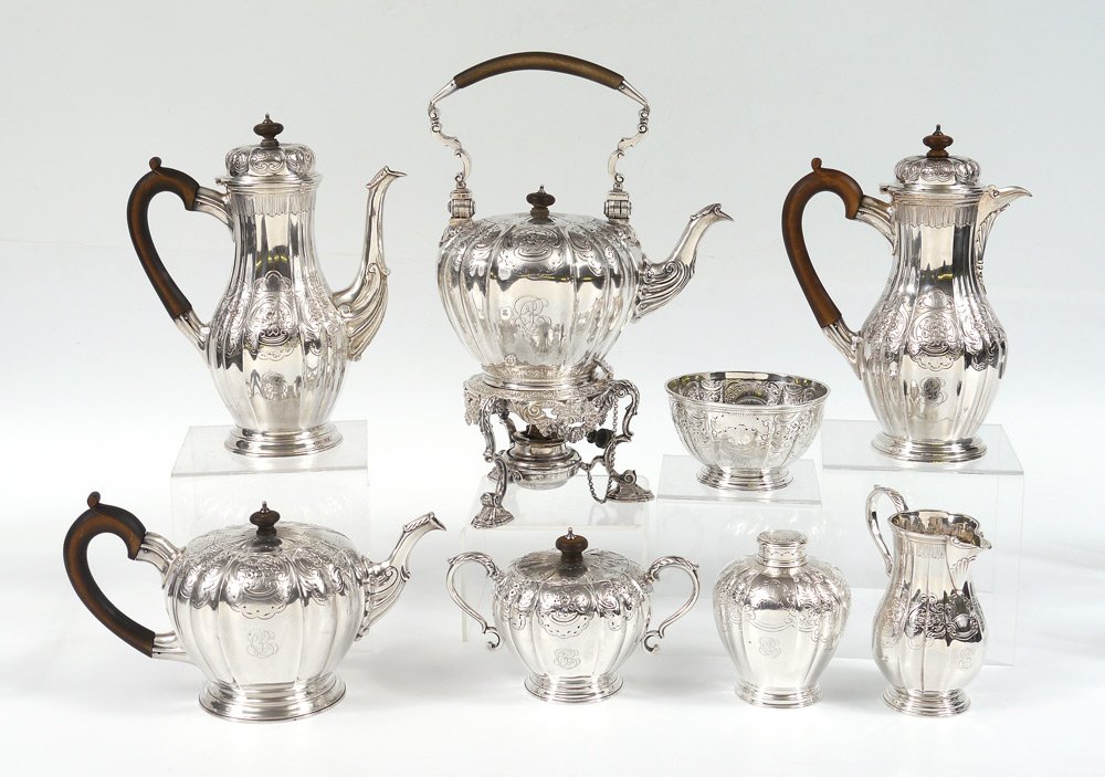 CRICHTON BROTHERS 8 PC ENGLISH SILVER TEA SERVICE: CRICHTON BROTHERS 8 PIECE ENGLISH SILVER TEA SERVICE: Circa 1912-13, embossed and engraved foliate motifs on each piece by Crichton Brothers, New York and London to include 1) Hot water kettle on stan