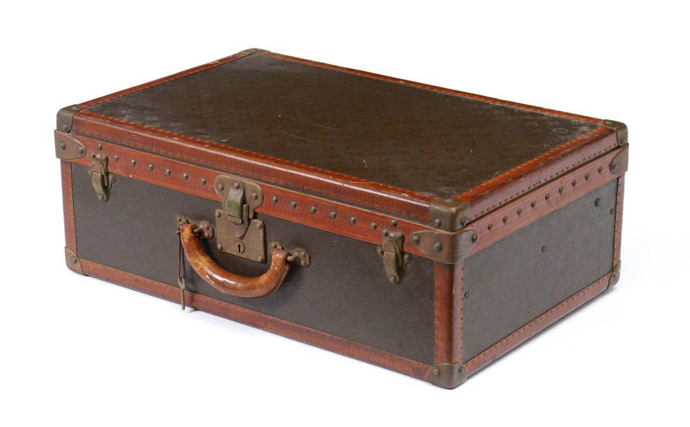 VINTAGE LOUIS VUITTON SUITCASE: VINTAGE LOUIS VUITTON SUITCASE: Early 20th century hard case with classic Louis Vuitton emblems, tacked leather borders. 2 interior labels to include Vuitton label with 70 Champs-Elysees Paris and 149