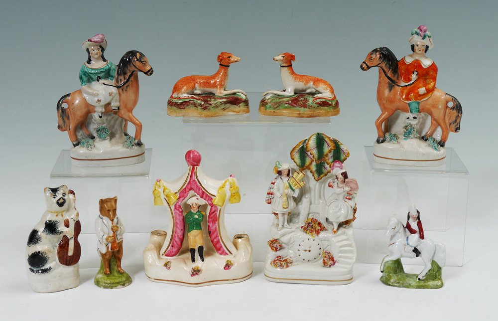 9 STAFFORDSHIRE FIGURINES: 9 STAFFORDSHIRE FIGURINES: An assembled collection to include 2 whippet dogs, figures on horse backs, cat with guitar, bear with musical instrument, figure in tent, figures with faux clock (6'' h. x 3