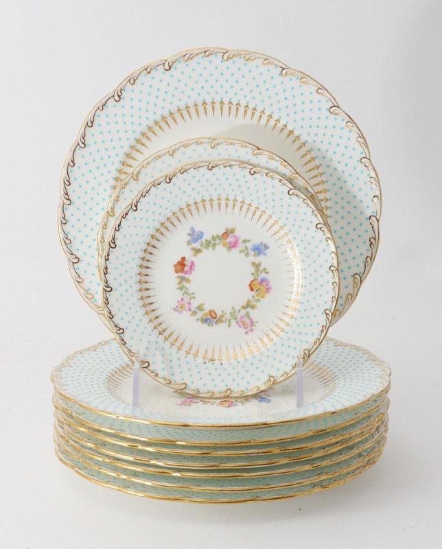 10 MINTON PLATES: 10 MINTON PLATES: 10 plates total, shaped rim with gilt decoration, applied blue dot border, floral garland center. 8 Marked with Mintons mark, retailed by Ovington Brothers, 7 3/4''. 2 retailed by Ti