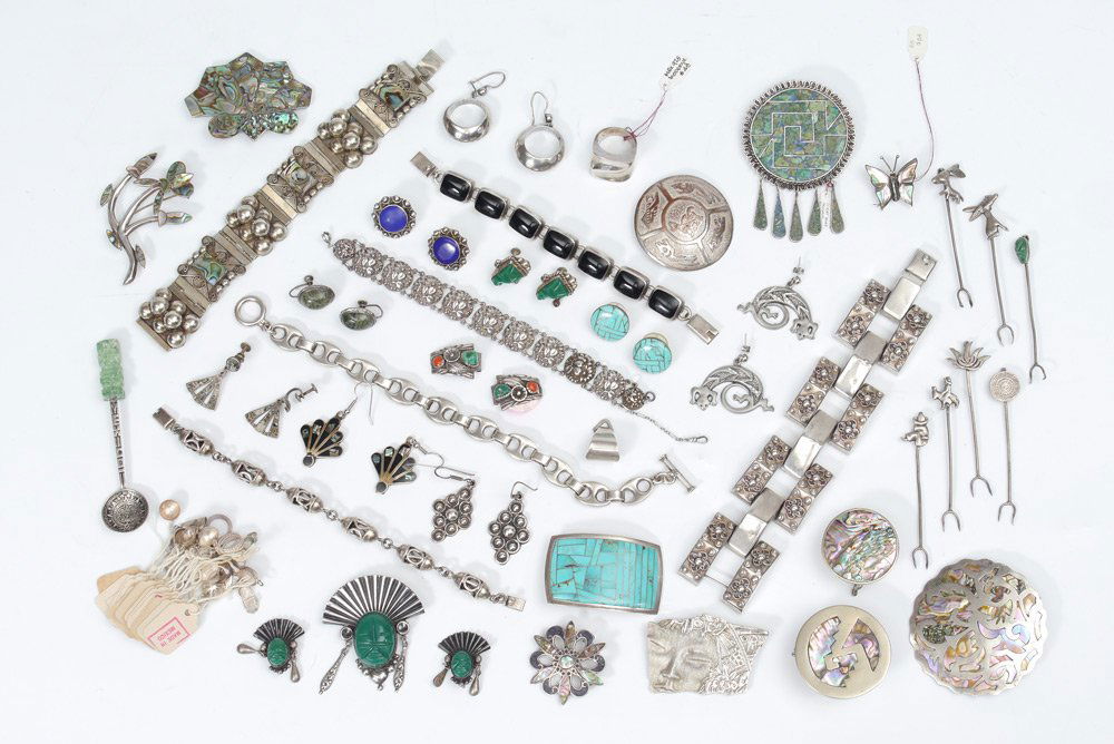 MEXICAN SILVER JEWELRY COLLECTION: MEXICAN SILVER JEWELRY COLLECTION: A large assembled collection to include 6 bracelets, pins, cocktail forks, ring, and earrings. Many pieces with stone or abalone shell inlay. Various makers. Approx.