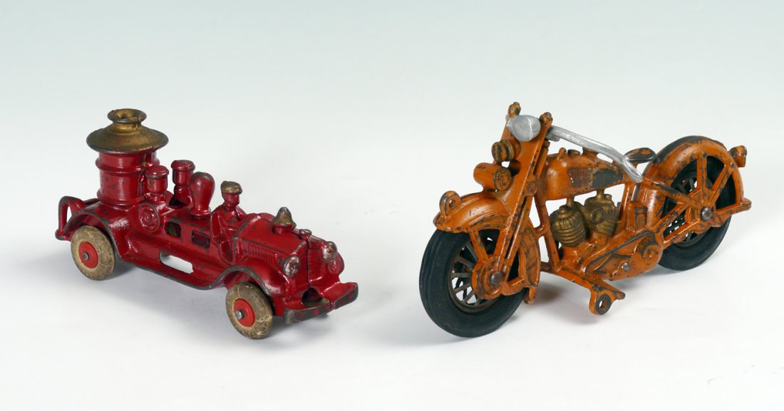 HUBLEY CAST IRON HARLEY DAVIDSON MOTORCYCLE: HUBLEY CAST IRON HARLEY DAVIDSON MOTORCYCLE: 2 pieces total to include 1) Large Harley Davidson with original orange paint and partial label, original wheels. Overall 4'' h. x 9''. 2) Cast iron fire t