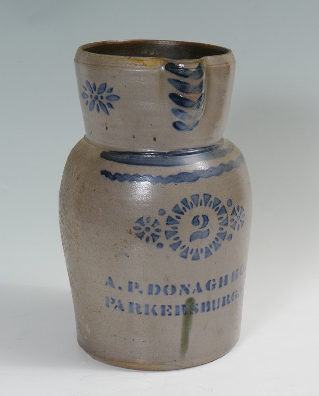 A.P. DONAGHHO 2 GALLON BLUE DECORATED STONEWARE PITCHER: A.P. DONAGHHO 2 GALLON BLUE DECORATED STONEWARE PITCHER: Stencil rosettes with #2, name A. P. Donaghho, Parkersburg, W. Va.. Hand painted at spout and throat. Measures 13 3/4" x 9 3/4".