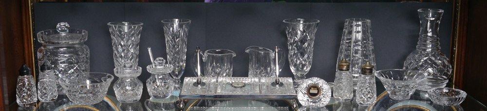 19 PC WATERFORD CRYSTAL MISC: GROUP OF WATERFORD CRYSTAL: 19 piece group to include biscuit jar, 2 mustard jars, 2 cream pitchers, water carafe, small clock, ashtray, desk set, 2 pairs salt and pepper, two 5" bowls, and 4 vases.