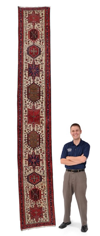 30 YR OLD PERSIAN KARAJA H K WOOL RUG 2'3" x 15': APPROX. 25-45 YR. OLD PERSIAN KARAJA HAND KNOTTED WOOL RUG, 2' 3" x 15': This is an attractive, long, runner whose design make-up follows traditional paths. The white ground of the field accentuates t
