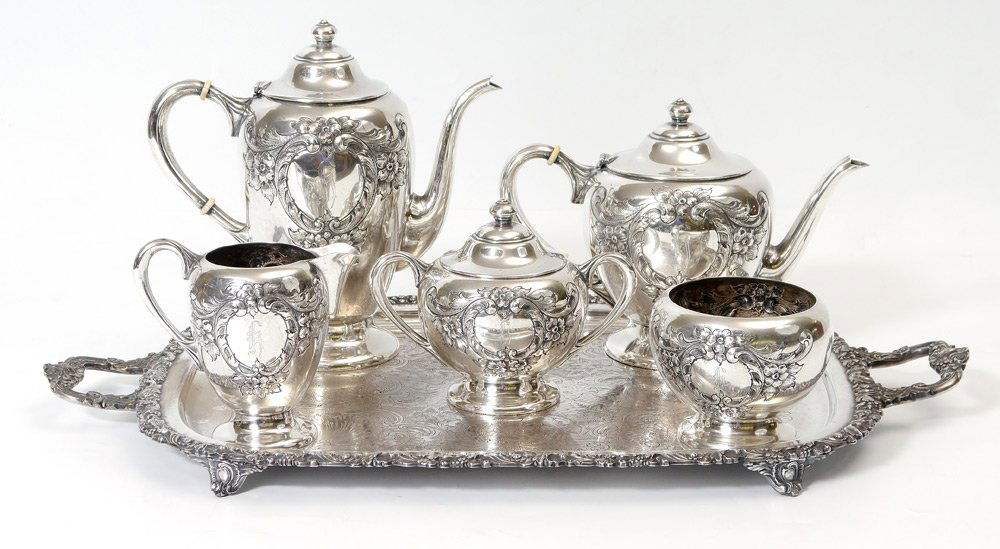 5 PIECE HAND CHASED STERLING TEA SERVICE: 5 PIECE HAND CHASED STERLING TEA SERVICE: Unidentified American maker, 6 pieces total, 5 piece tea service with chased foliate wreath and monogram on each to include 1) Coffee pot with hinged lid, 10'