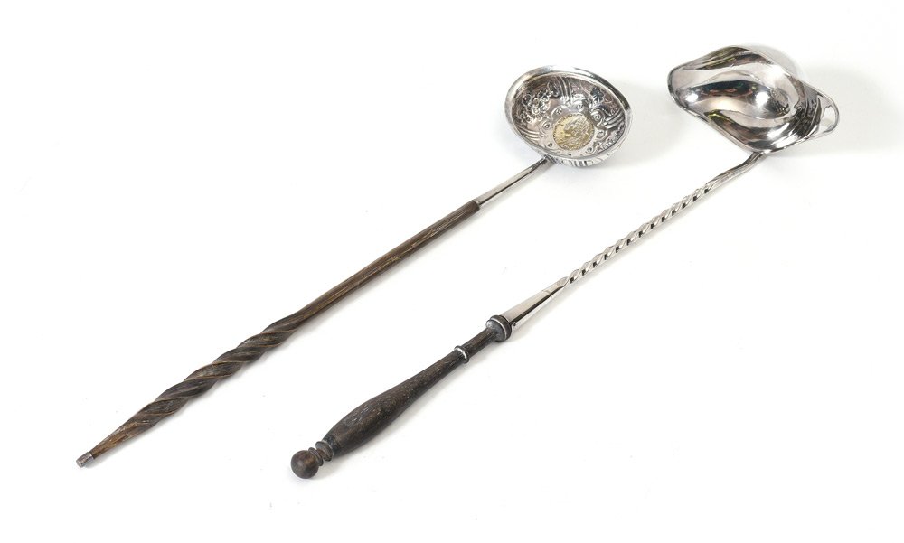 2 PIECE CHRISTOFLE & ENGLISH TODDY LADLES: 2 PIECE CHRISTOFLE & ENGLISH TODDY LADLES: 2 pieces total to include 1) French Christofle silverplate toddy ladle with turned ebony handle. Overall 14 3/4'' long. 2) Silvered toddy ladle, floral motif