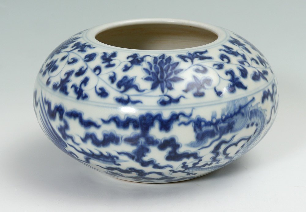CHINESE BLUE & WHITE DRAGON POT: CHINESE BLUE & WHITE DRAGON POT: Blue and white decoration with floral motif top rim. Spurious Qing dynasty marks on base. Measures 3 7/8'' h. x 7 1/4''.