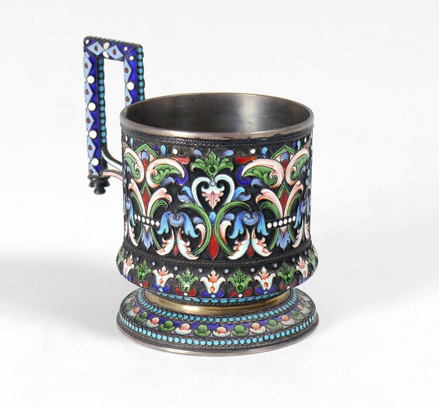 IVAN SALTIKOV RUSSIAN ENAMEL TEA CUP HOLDER: IVAN SALTIKOV RUSSIAN ENAMEL TEA CUP HOLDER: Profusely enameled in foliate motifs, 1882-1899, Moscow 84 zolotnik and Salitkov makers hallmark on base. Overall measures 4" h. x 4 1/4", approx. 6.3 troy