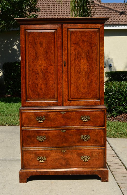 SOUTHAMPTON BURL WALNUT LINEN PRESS: SOUTHAMPTON BURL WALNUT LINEN PRESS: Burl walnut veneer, 2 doors with 4 shelves over 3 drawers with brass pulls, shaped skirt. Southampton brass plaque inside drawer. 72" h. x 39 3/4" x 22".