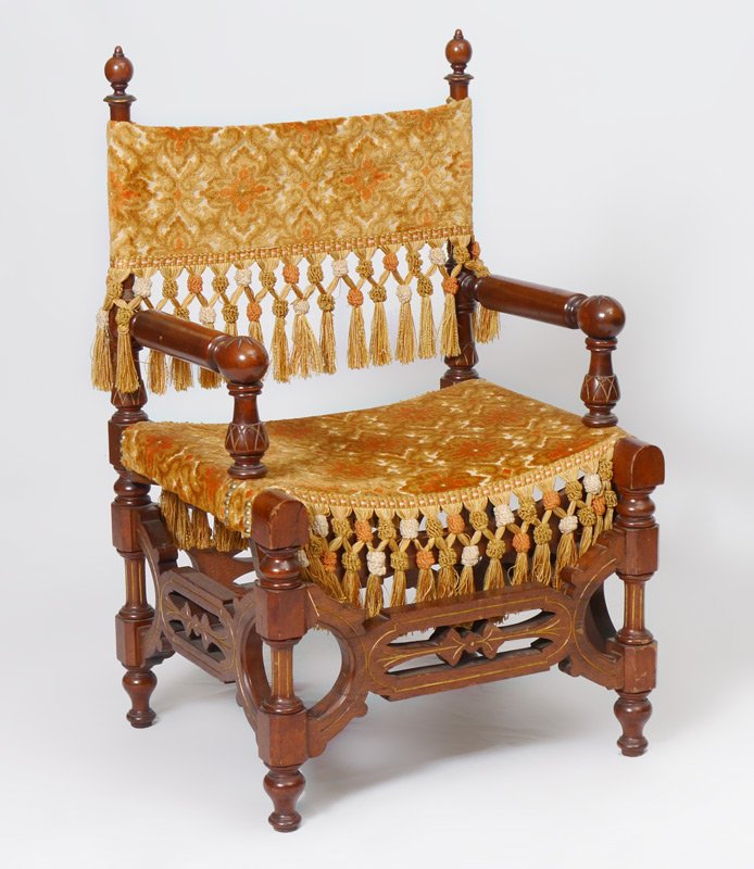 VICTORIAN RENAISSANCE REVIVAL ARM CHAIR: VICTORIAN RENAISSANCE REVIVAL ARM CHAIR: Diminutive arm chair with carved and turned frame. Heavy floral motif upholstery with tassels. Measures 34 1/4" h. x 21" x 18 1/2".