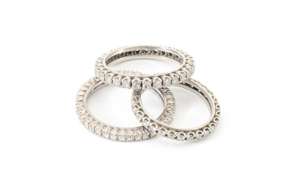 PLATINUM & GOLD DIAMOND ETERNITY BAND 1.25 CTW: SET OF 3 DIAMOND ETERNITY BAND RINGS: Three stacking bands of diamonds. One is platinum, two are 14K gold. Diamonds total approx. 1.25 Ct., averaging VS-SI in clarity, G-H color. Sizes 5 and 7. Platin