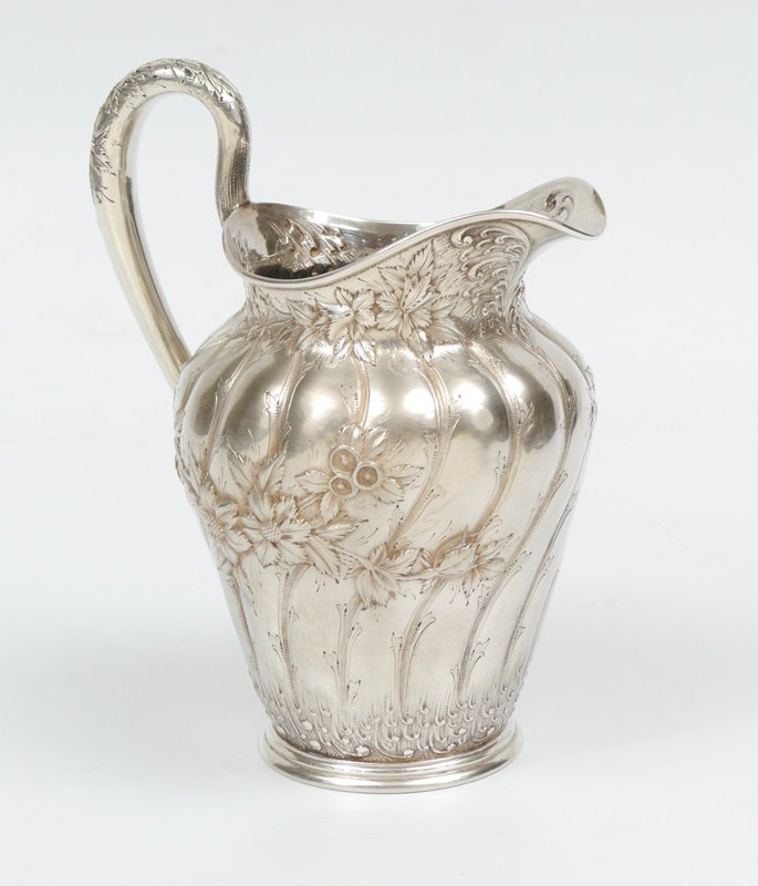 S KIRK & SON CO STERLING PITCHER 23.9 Troy oz: S KIRK & SON CO STERLING PITCHER: Repousse floral pattern with swirl ribs to body, high arched handle, marked on base S.Kirk & Son Co 925/1000 162. Circa 1896-1924. 10"h. overall, 23.9 Troy oz.
