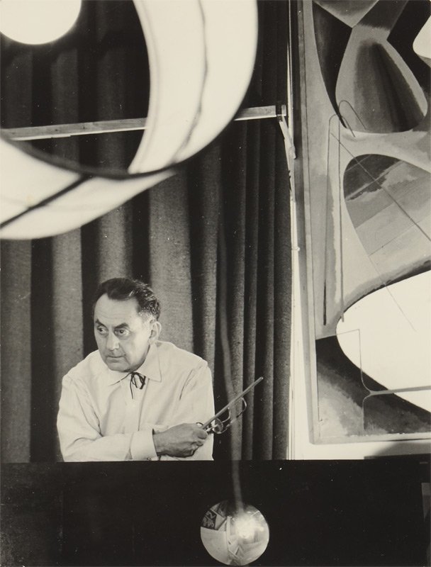 MAN RAY PORTRAIT PHOTOGRAPH: MAN RAY PORTRAIT PHOTOGRAPH: Photographer unknown, 8 3/4" x 6 1/2", USIS stamp verso.