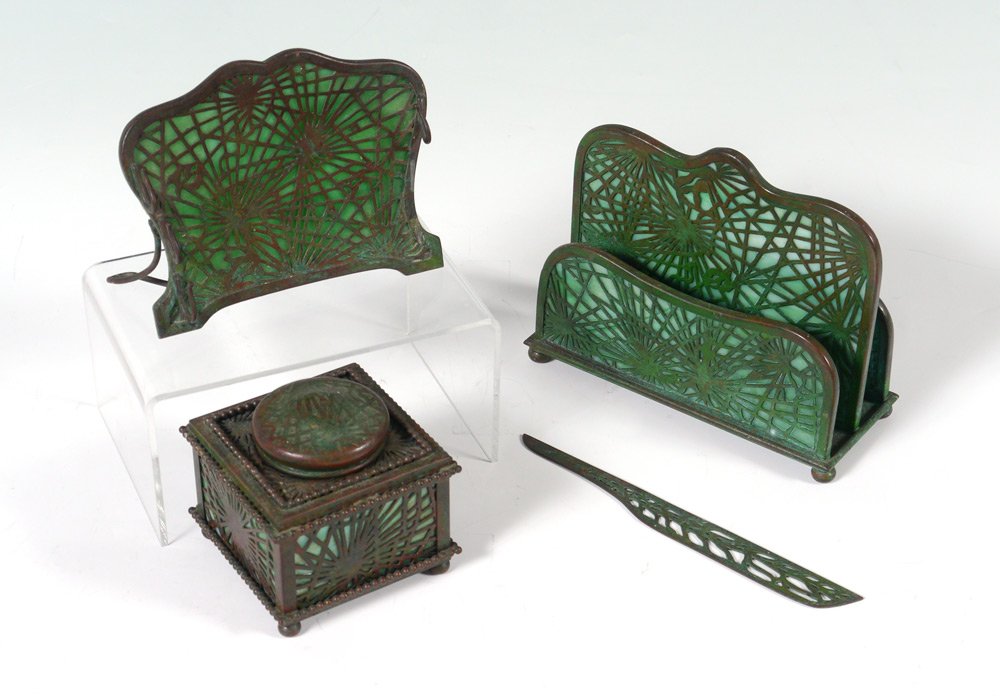 4 PIECE TIFFANY PINE NEEDLE DESK SET: 4 PIECE TIFFANY PINE NEEDLE DESK SET: 4 pieces total, all marked Tiffany Studios New York, to include 1) #845, inkwell, missing insert, 3'' h. x 3 3/8'' x 3 3/8''. 2) #1019, letter holder, 5'' h. x 6 