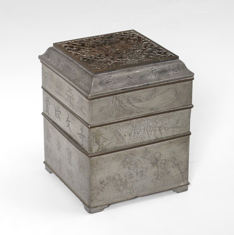 CHINESE SQUARE PEWTER INCENSE CLOCK: CHINESE SQUARE PEWTER INCENSE CLOCK: In 3 levels with reticulated lid, lower level with removable tray. The clock bodies are specialized censers that hold a measured amount of incense to accurately me