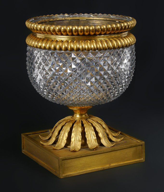 BACCARAT QUALITY DORE BRONZE & CUT GLASS BOWL: BACCARAT QUALITY DORE BRONZE & CUT GLASS BOWL: Gadroon bronze dore rim mounted to sharply cut glass center bowl. Dore square base with foliate motif, no visible mark. Overall measures 10" h. x 8".
