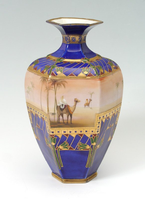 NIPPON HEXAGONAL ORIENTALIST MOTIF VASE: NIPPON HEXAGONAL ORIENTALIST MOTIF VASE: 6 sided vase by Morimura Brother with center hand painted Egyptian desert motif. Flanked above and below with cobalt blue glaze, foliate and geometric decorati