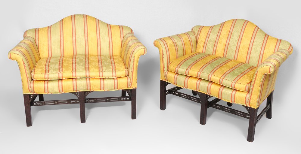 PAIR CHINESE CHIPPENDALE STYLE SETTEES: PAIR CHINESE CHIPPENDALE STYLE SETTEES: Mahogany framed camel back, rolled arm settees, late 19th to early 20th C. Each measure approx. 33"h. x 43" long x 33".
