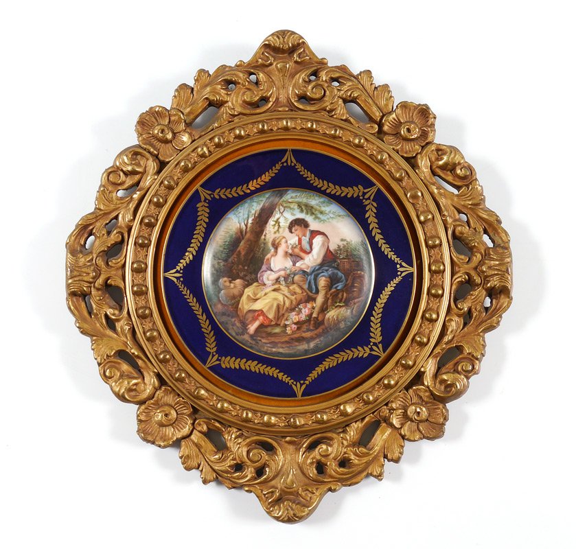 SIGNED FRAMED PORTRAIT PLATE: SIGNED FRAMED PORTRAIT PLATE: Sevres style, embellished transfer scene of lover, signed Donato, cobalt rim with gilt garland decoration, 9 5/8'' dia. Framed in carved gilt wood frame, 19'' x 17''.
