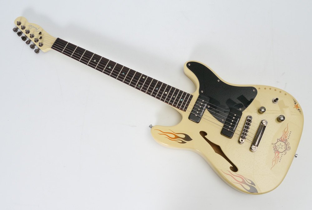 KOREAN FENDER TELECASTER SEMI-HOLLOWBODY GUITAR: KOREAN FENDER TELECASTER SEMI-HOLLOWBODY GUITAR: Ivory body with after market applied flame and shield transfer decoration, Seymour Duncun pickups, Levy's strap. Serial number 040620018. Sold with loc