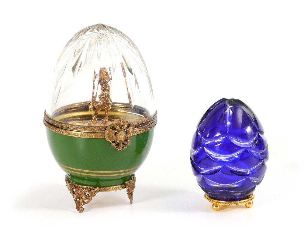 SMALL COBALT FABERGE CRYSTAL EGG IN BOX: SMALL COBALT FABERGE CRYSTAL EGG IN BOX AND TROPHY: 2 pieces total to include 1) Stamped on gilt metal base Faberge, 0413, 3 ball feet. 2 5/8'' h. x 1 7/8''. Sold with original presentation box, 2 1/4
