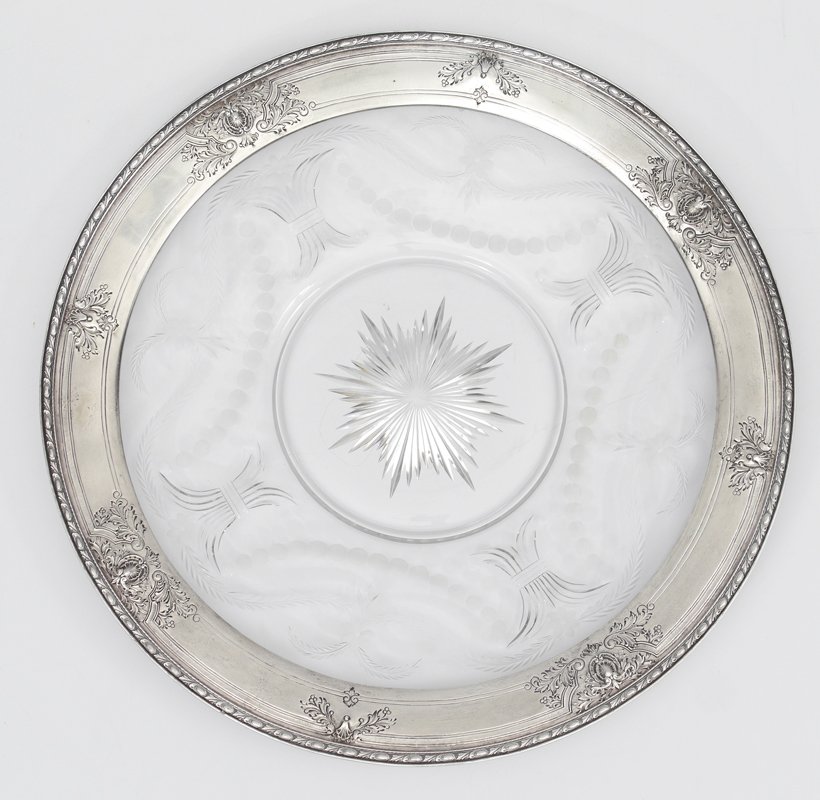 WATSON NAVARRE STERLING RIM CUT GLASS SERVING TRAY: WATSON NAVARRE STERLING RIM CUT GLASS SERVING TRAY: Large round serving tray by Watson, cut glass center with starburst and swags, sterling rim with embossed decoration marked with Watson mark, Sterli