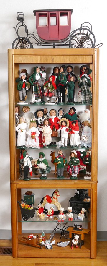 32 BYERS CHOICE CAROLERS: ORIGINAL BYERS CHOICE "THE CAROLERS": Approx. 32 pieces to include Santa, Mrs. Claus, village ice skaters, children in International dress, Organ grinder. Hand crafted in Chalfont PA USA. Sold with th