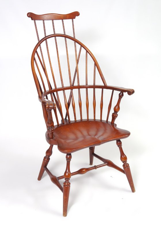 COMB-BACK WINDSOR CHAIR: COMB-BACK WINDSOR CHAIR: High back with shaped top rail, curved back with spindle supports, carved hand holds, shaped seat, on 4 turned legs with stretchers. Overall measures 46 1/2" h. x 25 1/4" x 24