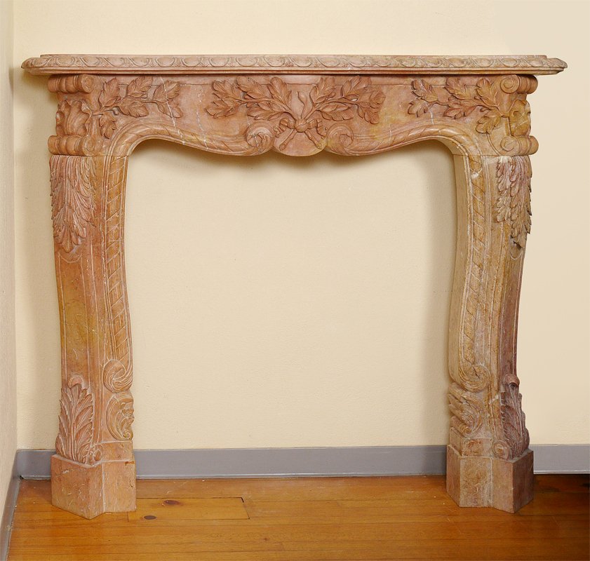 CARVED ROSSO VERONA MARBLE FIRE SURROUND: CARVED ROSSO VERONA MARBLE FIRE SURROUND: Shaped top, carved floral and foliate motif pediment and supports. Overall measures approx. 57 1/4'' h. x 67'' x 14 1/2''.