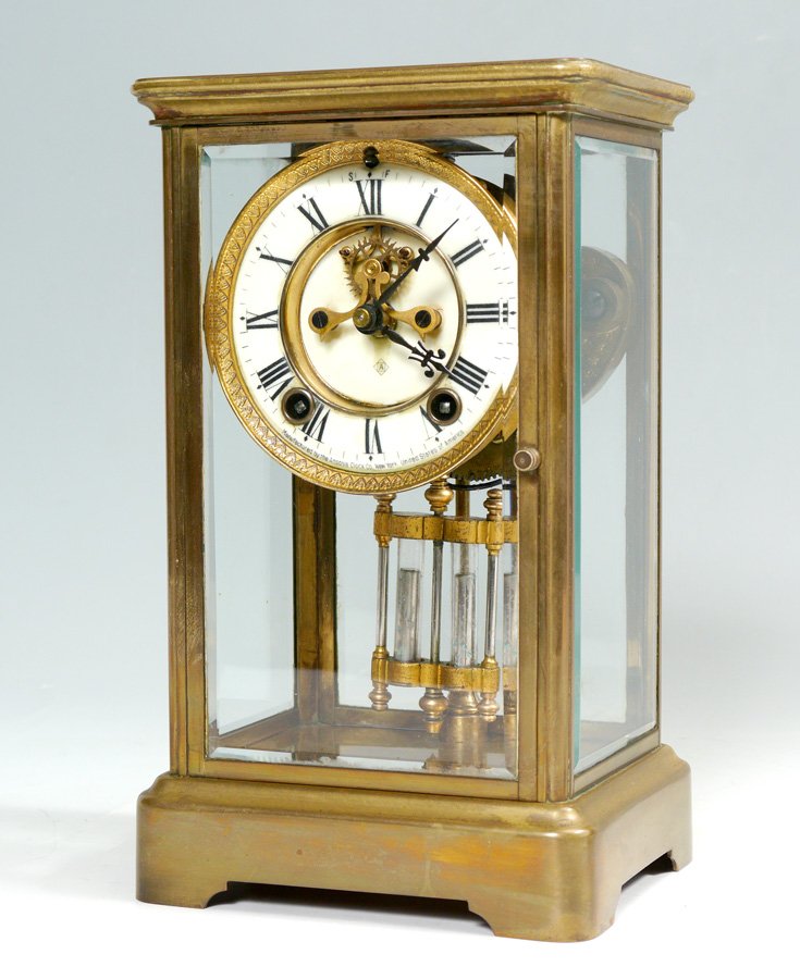 ANSONIA CRYSTAL REGULATOR CLOCK: ANSONIA CRYSTAL REGULATOR CLOCK: Brass case with beveled glass sides, porcelain dial with Roman numerals marked Ansonia. Time and strike Ansonia movement. Overall measures 10 3/4" h. x 6 3/8" x 5 1/4"