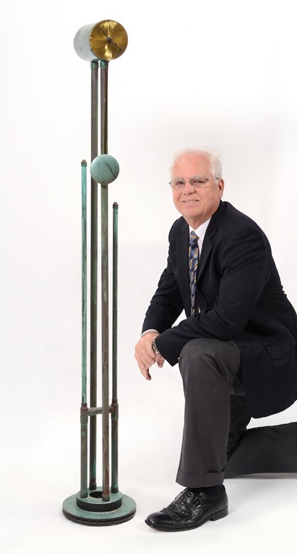 UPCYLCLED FOLK ART FLOOR LAMP: UPCYLCLED FOLK ART FLOOR CLOCK: Faux painted clock, upcycled from a brake drum, copper pipes and metal cylinder. Quartz movement with pendulum, no visible signature or maker. Measures 60 1/2" h. x 9 1