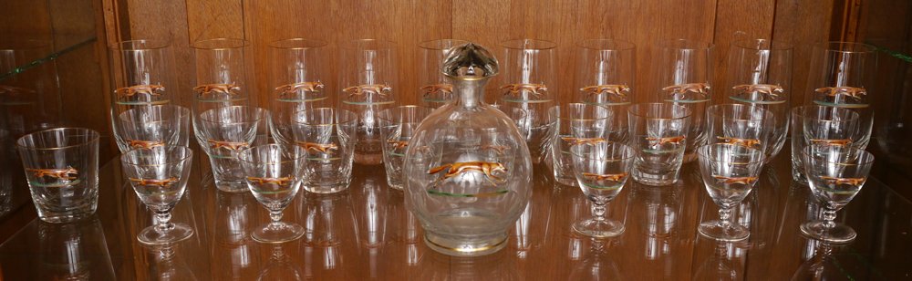 26 PIECE ENAMEL FOX GLASS LIQUOR SET: 26 PIECE ENAMEL FOX GLASS LIQUOR SET: 27 pieces total with raised enamel fox running decoration to include decanter (8" h. x 5"), 10 tall water glasses (6 1/4"), 10 whiskey (3 1/2"), 5 cordial (3 1/2"