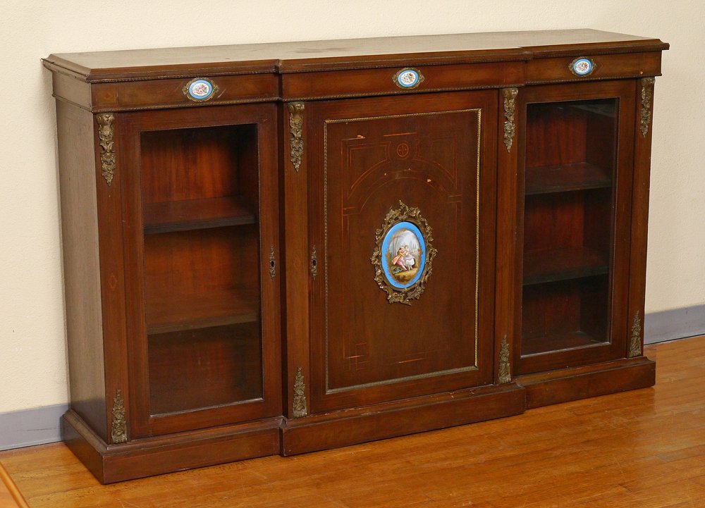 INLAID WALNUT SIDEBOARD WITH PORCELAIN PLAQUES: INLAID WALNUT SIDEBOARD WITH PORCELAIN PLAQUES: Shaped top and front with gadroon metal trim. Front with 3 small porcelain plaques, center door with geometric string inlay, porcelain plaque with outdo