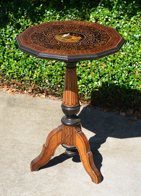 EDWARDIAN INLAID FERN STAND TABLE: EDWARDIAN INLAID FERN STAND TABLE: Dodecagon top, center medallion with cherubs and stork, foliate center ring, parquetry rim. Turned column support, splayed legs. Overall measures 27 3/4" x. 19 1/2".
