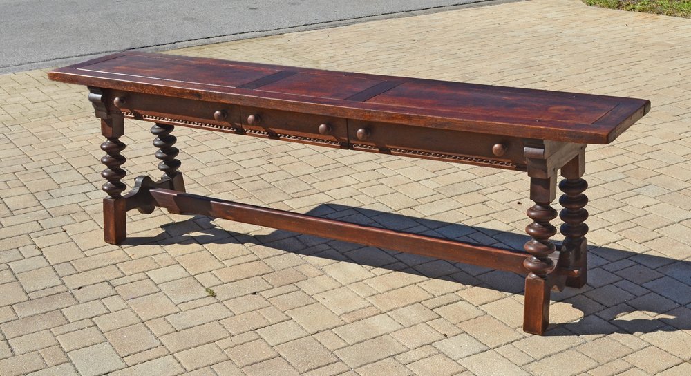 MASSIVE OAK HUNT BOARD: MASSIVE OAK HUNT BOARD: Paneled top over 3 drawers with turned wood handles, turned legs, through tenon stretcher. Overall 29 1/2" h. x 97 3/4" x 19". Age unknown