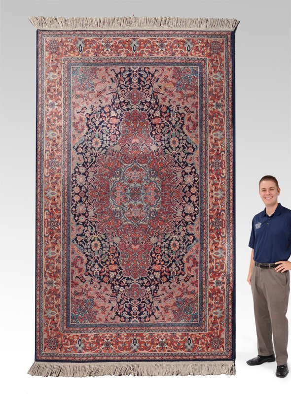 25YR OLD KARASTAN MACHINE MADE WOOL RUG 5'9" x9'2": APPROX 20-30 YR OLD KARASTAN MACHINE MADE WOOL RUG, 5'9" x 9'2": This rug has a traditional Persian rug design and colors. Although this is a machine loomed rug, it still has a lovely look to it in ad