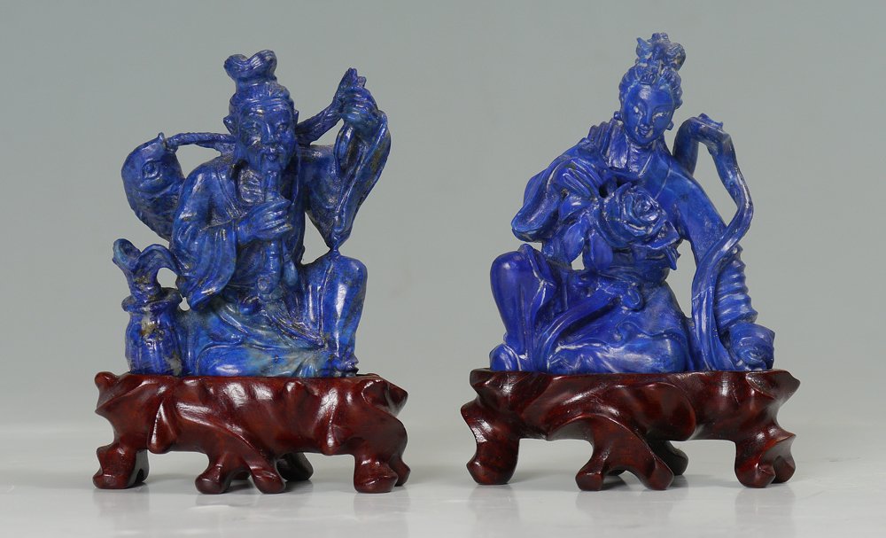2 PIECE CHINESE CARVED SODALITE FIGURES: 2 PIECE CHINESE CARVED SODALITE FIGURES: 2 figures to include 1) Fisherman with catch and pipe, 2 7/8" h. x 2 1/4", carved fitted wood base. 2) Figure of a seated woman with large blossom, 2 3/4" h. x