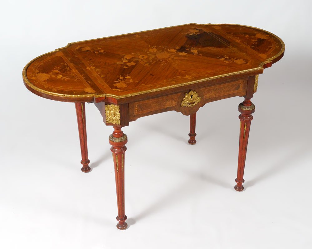 LOUIS XVI STYLE MARQUETRY DROP LEAF TABLE: LOUIS XVI STYLE MARQUETRY DROP LEAF TABLE: Floral marquetry inlaid top and side drop leaves with gilt metal trim. Skirt with single drawer, applied ormolu mounts on drawer and corners. Reeded tapered 
